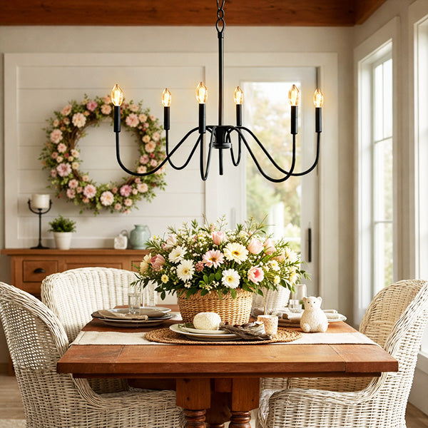 Dining room with a wooden table, floral centerpiece, and decorative wreath on the wall.