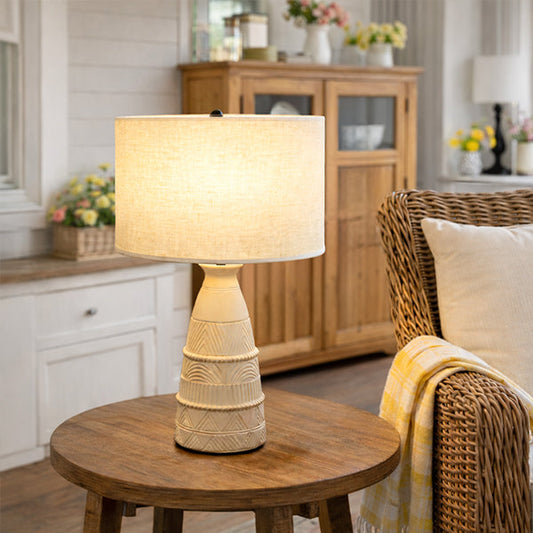 Decorative table lamp on a wooden table in a cozy living room.